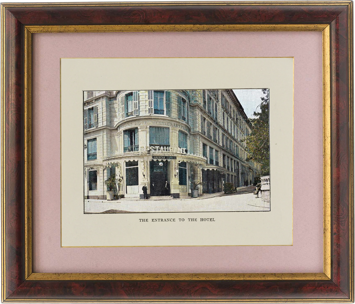 Framed print of a hotel entrance with a pink border and gold frame.