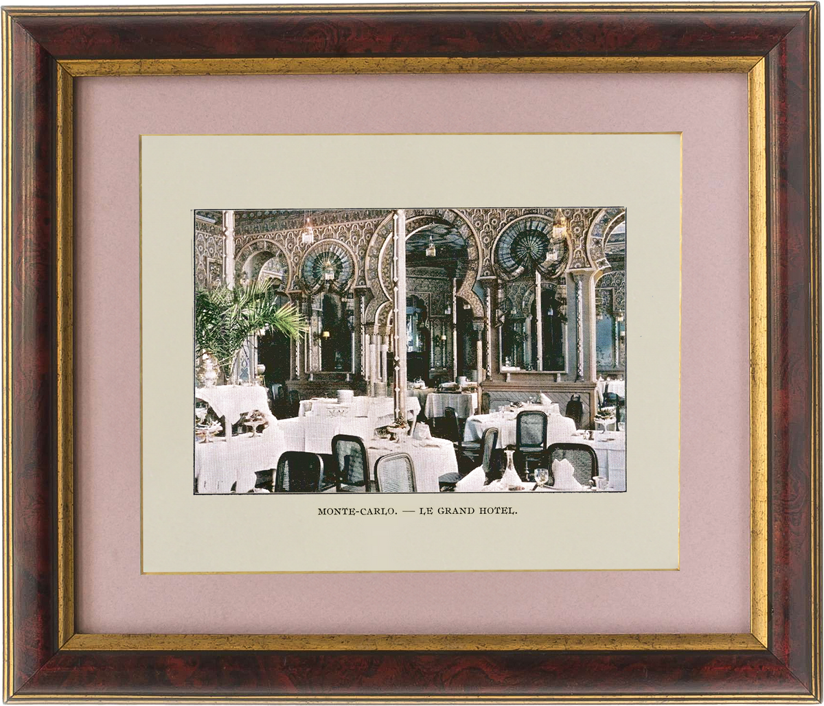 Framed print of a grand hotel interior with ornate architecture and tables.