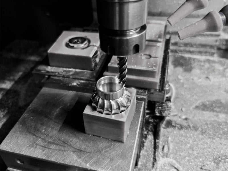 CNC machine in operation with Moëhr zinc cap being machined.