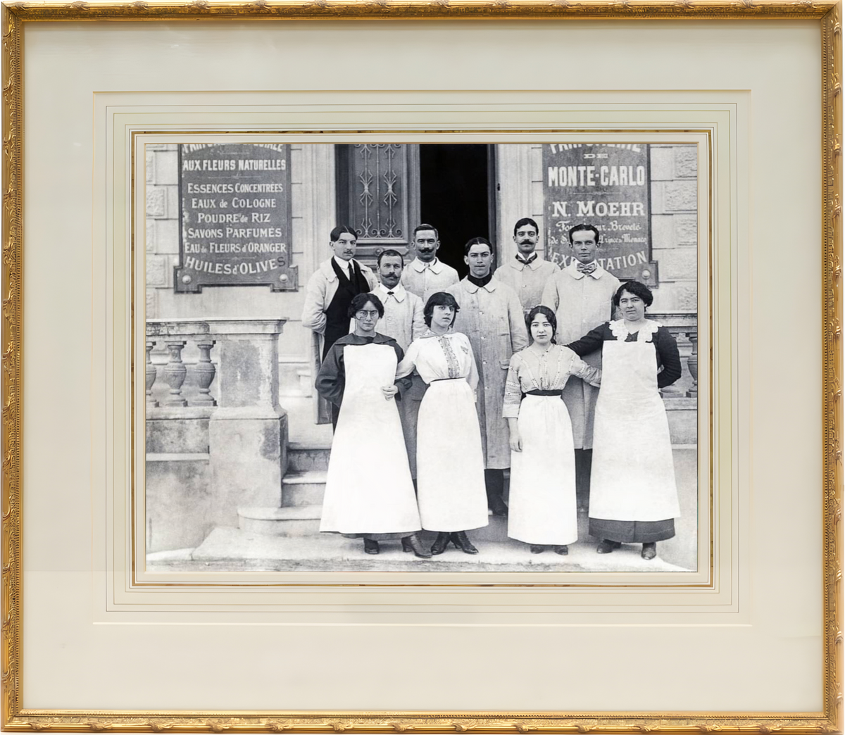 Framed black and white photograph of a group of people in front of a store with posters.