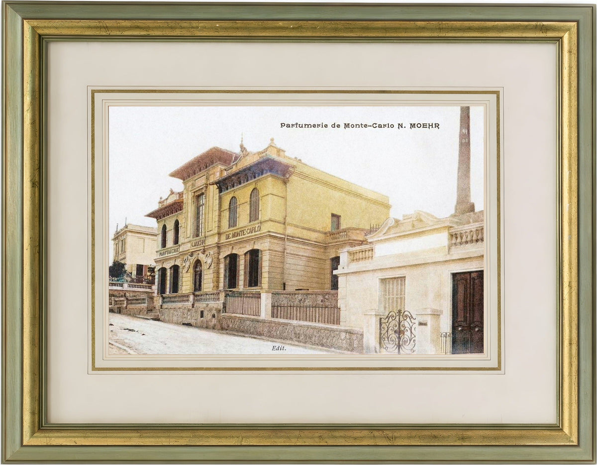 Framed vintage-style print of la parfumerie de monte-carlo with a gold frame.